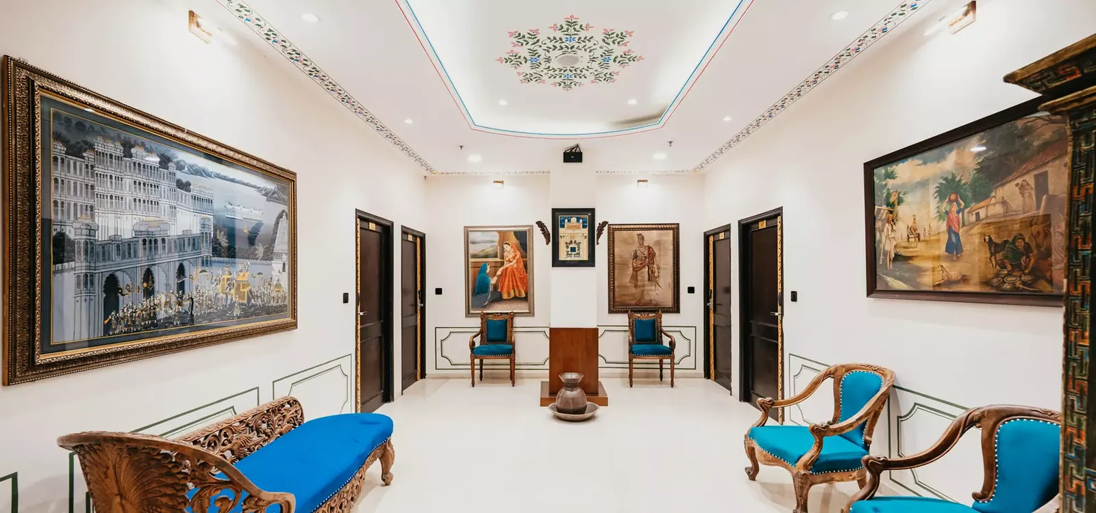 Heritage lobby with antique furniture and Mewar paintings at The Chronicles Hotel